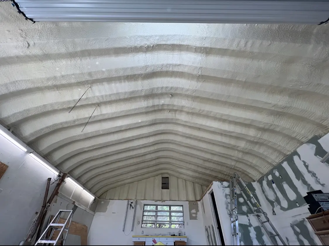 Spray polyurethane foam applied to the underside of a metal roof deck in Cameron